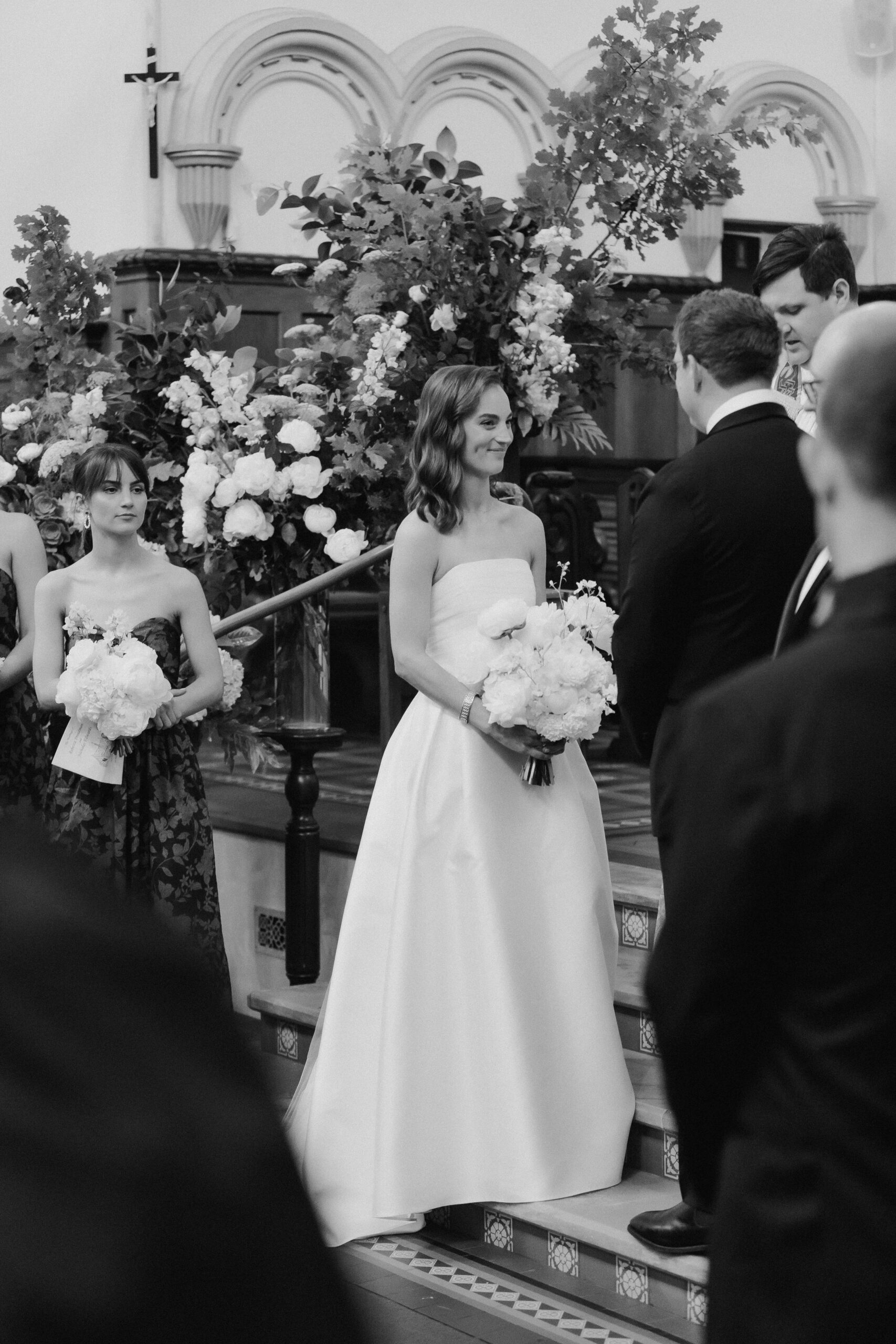 Bride smiling at groom in front of guests