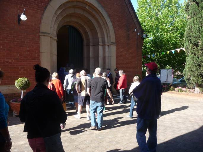 People arriving and sharing conversation at Christ Church North Adelaide.